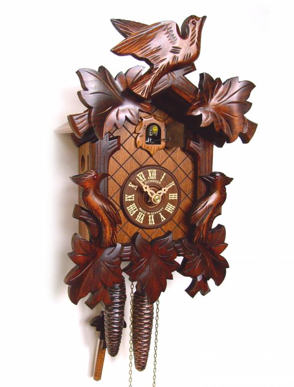 Cuckoo clock with carved headpiece